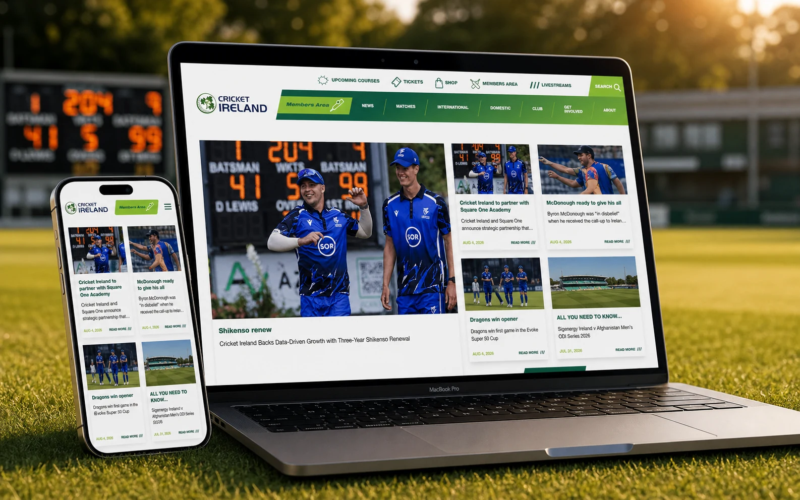 Cricket Ireland website shown on a MacBook and iPhone on a cricket ground.