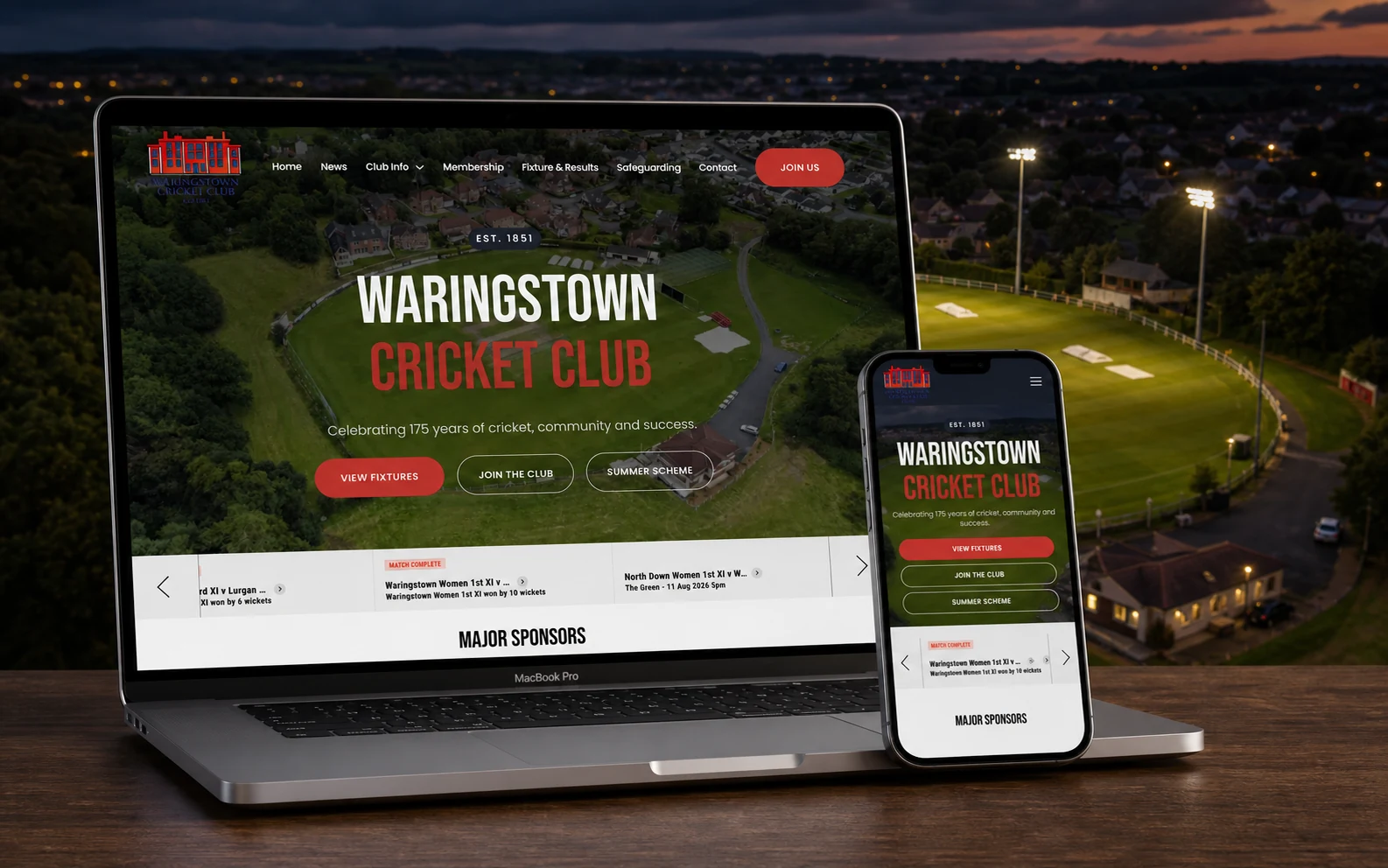 Waringstown Cricket Club website shown on a MacBook and iPhone above the club ground at dusk.